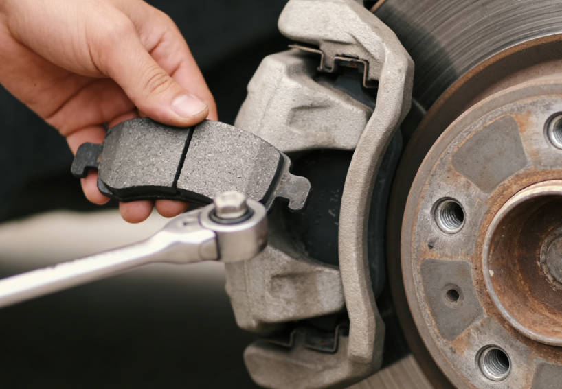 Install new brake pads with shims